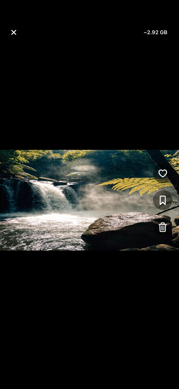 ClearSpace full-screen view of a waterfall photo labelled ~2.92 GB, with heart, bookmark and trash controls stacked down the right edge.